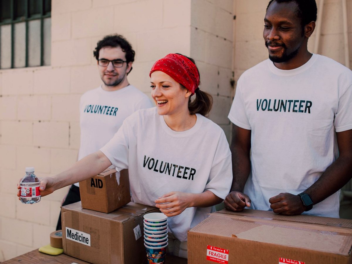Charity volunteers at an aid table handing out water